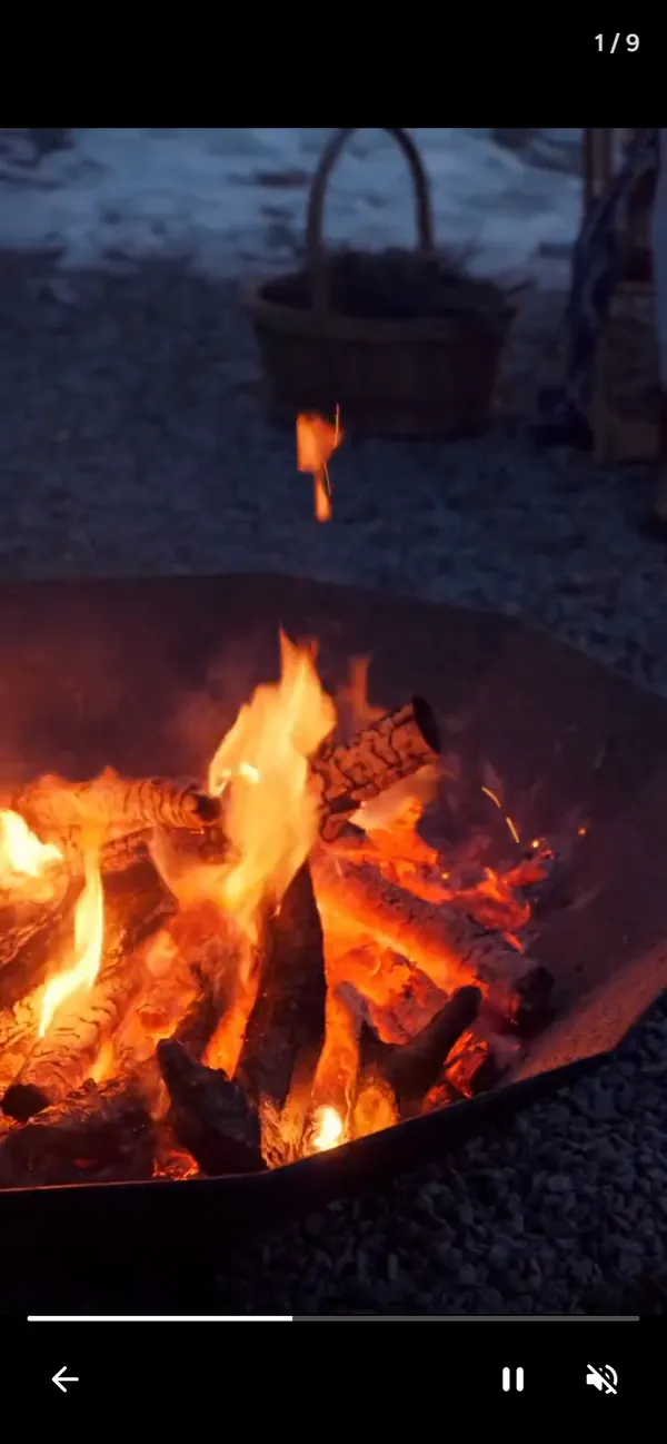 Full-screen video of a fire pit in the guest manual's video feed